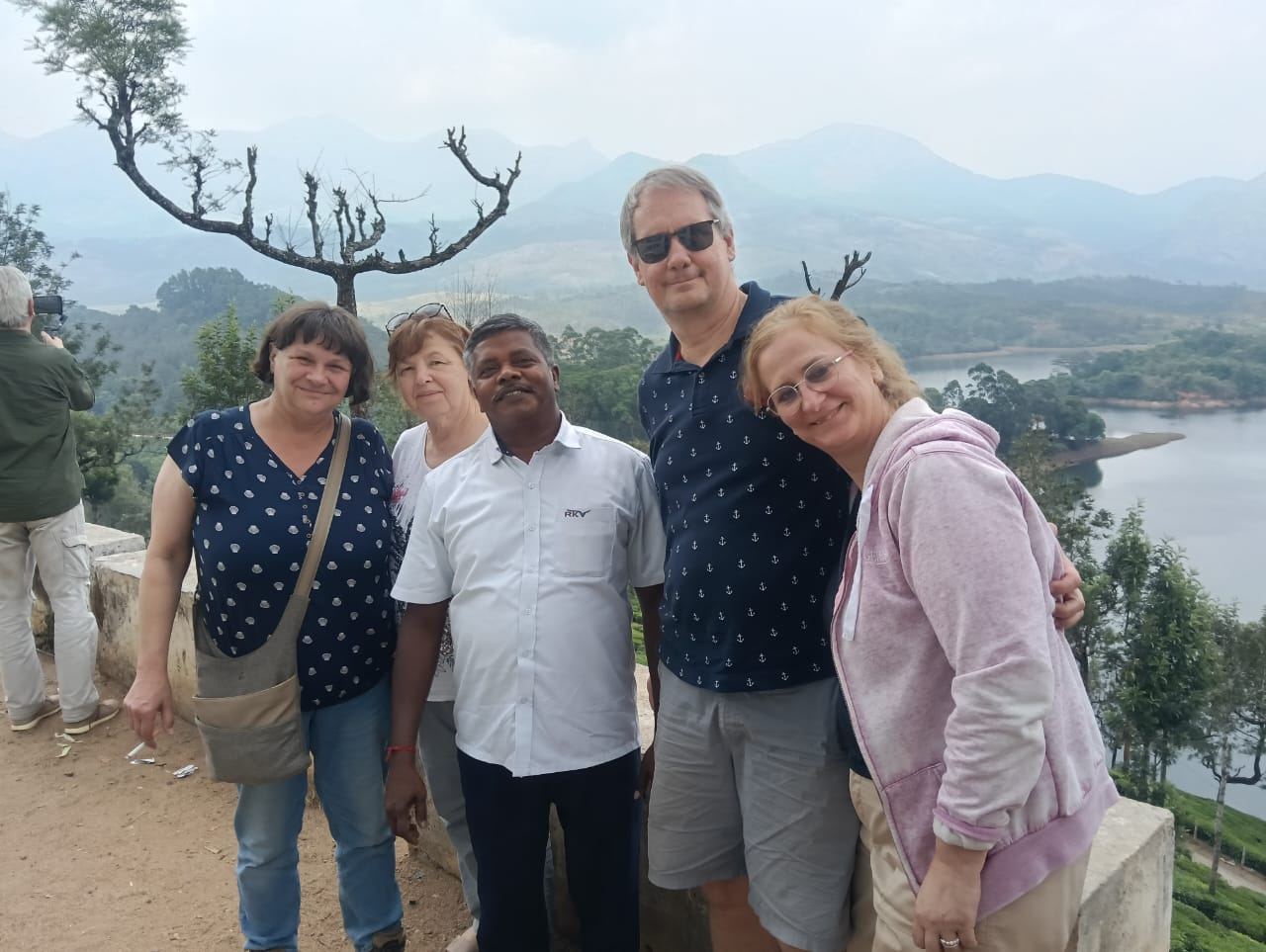 RKV Travels driver with guests in front of a mini coach